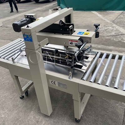 220V / 50HZ स्वचालित पैकिंग मशीन 12 मिमी कार्टन बॉक्स सीलर चिपकने वाला टेपिंग